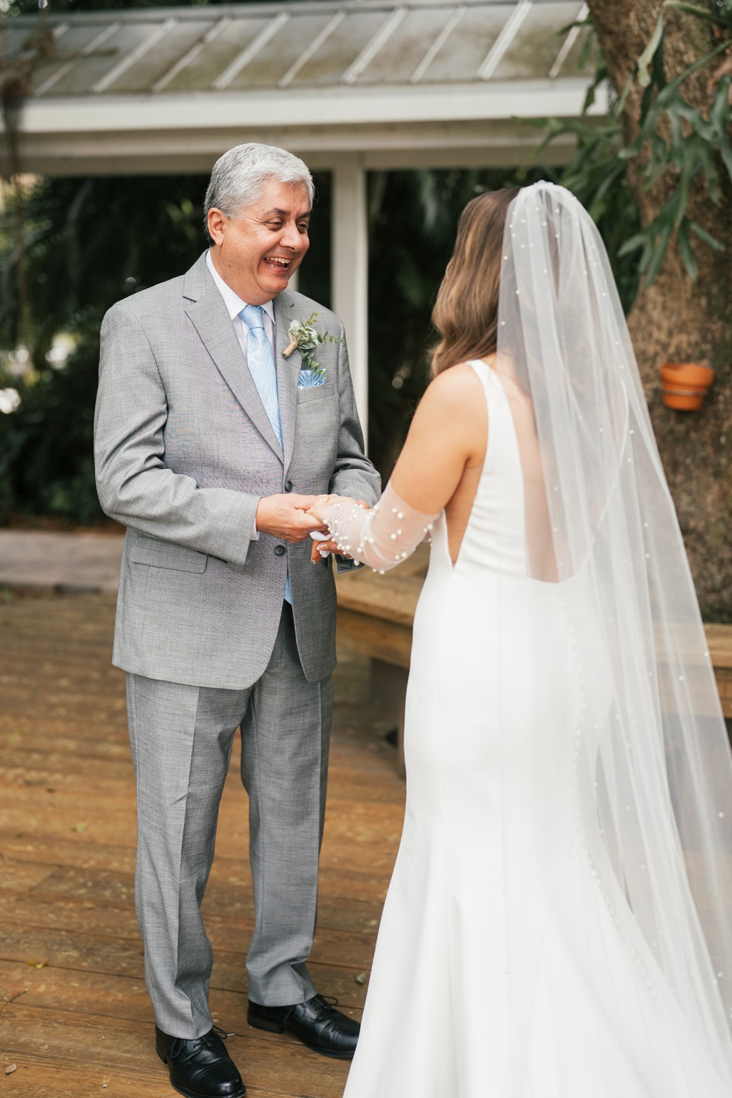 Chellsea's father laughing during their first look on the porch at Up the Creek Farms