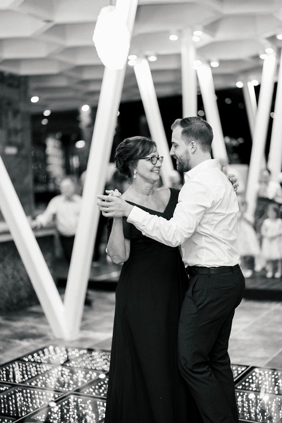 Black and white of Brian dancing with his mother on the reception dance floor