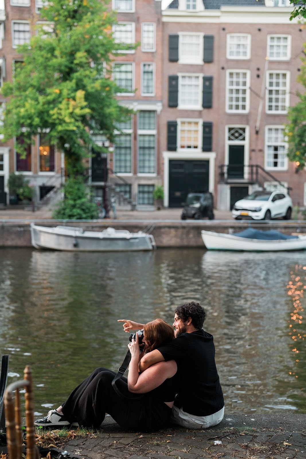 Couple portrait against an Amsterdam canal house facade