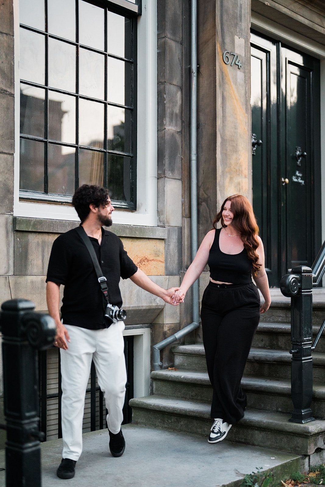 Couple portrait against an Amsterdam bridge railing