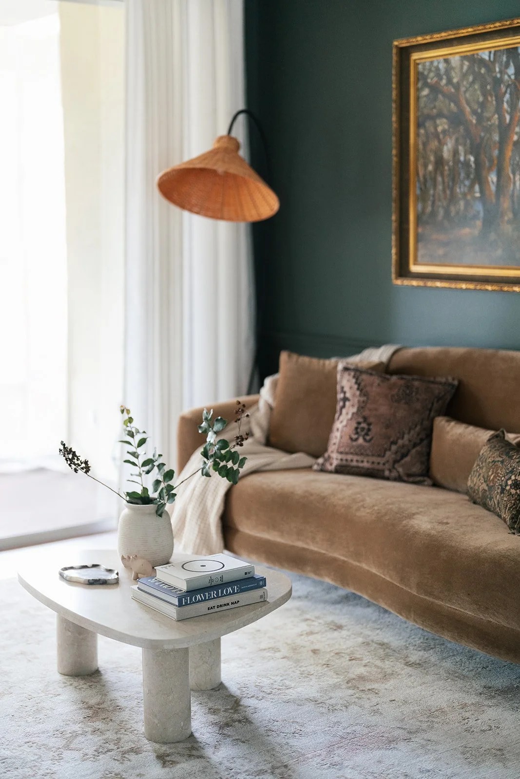Living room with beige velvet sofa and patterned pillows