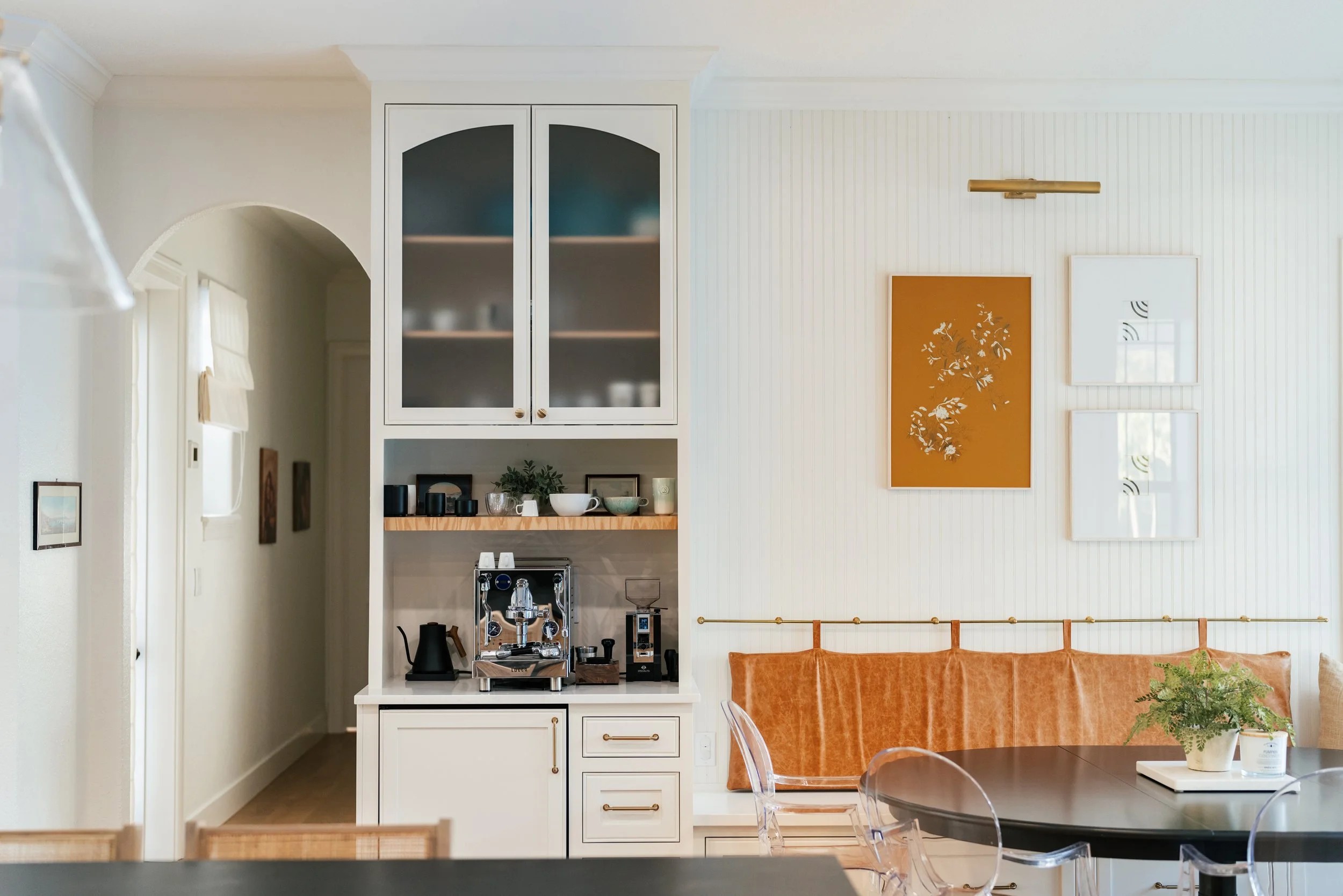 Kitchen corner with built-in cabinet, coffee station, and dining table